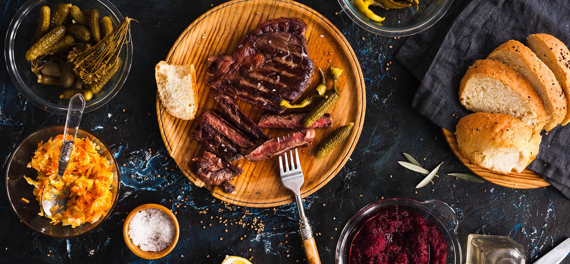 Photo shows a medium-rare steak on a board sliced into pieces